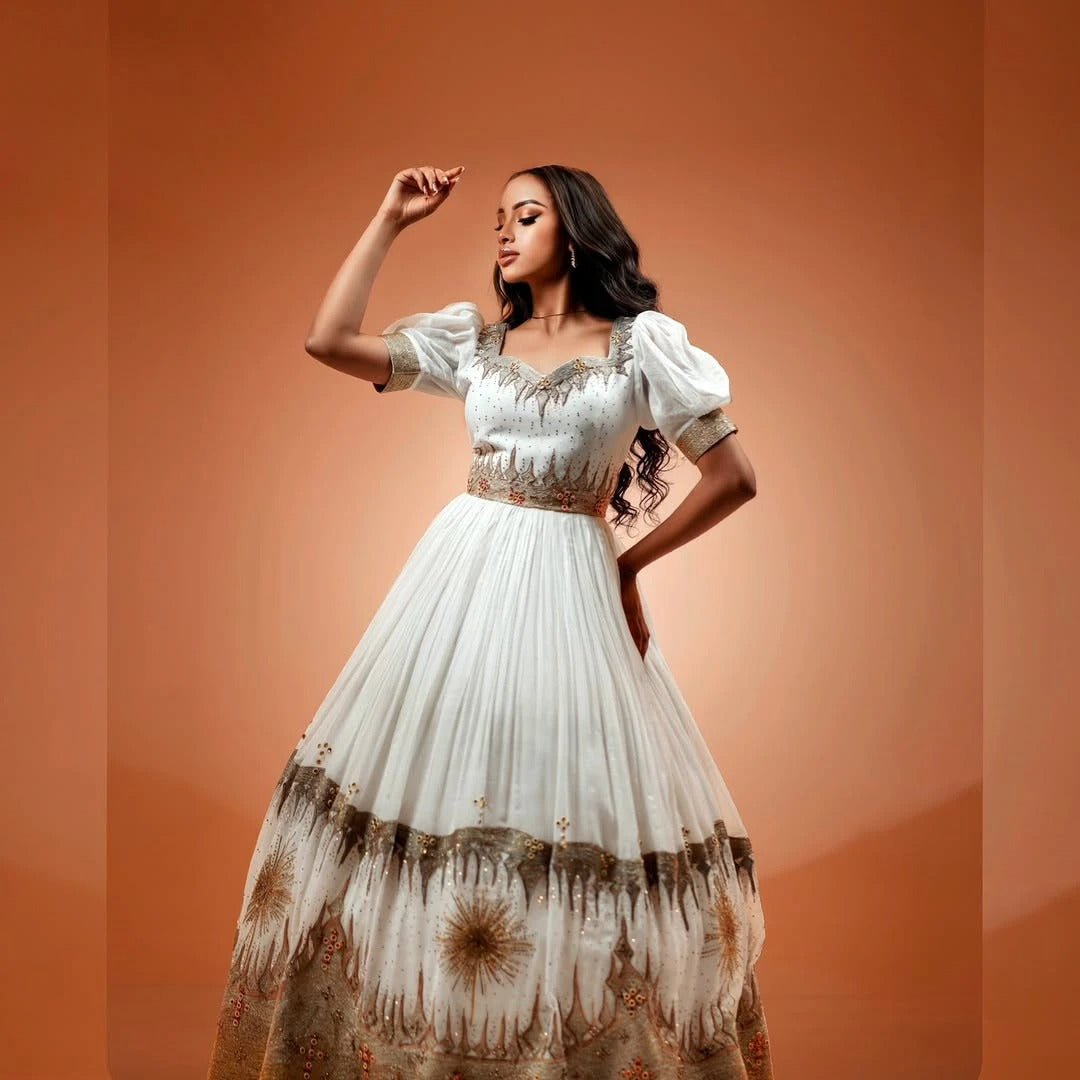 Gray Elegance Habesha Wedding Dress: Golden Floral Hemline Embroidery for Modern Brides
