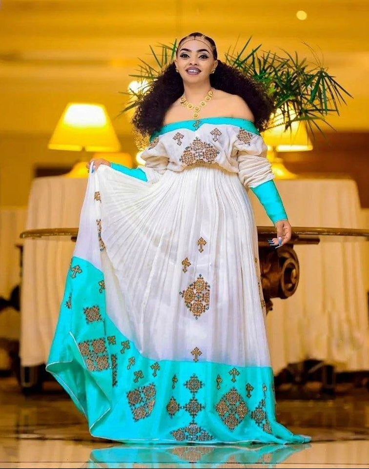 Elegant Vibrant Blue Habesha Kemis with Intricate Cross Design