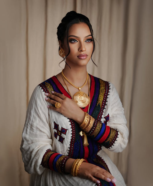 beautiful Ethiopian lady wearing a beautiful habesha dress and Ethiopian jewelry
