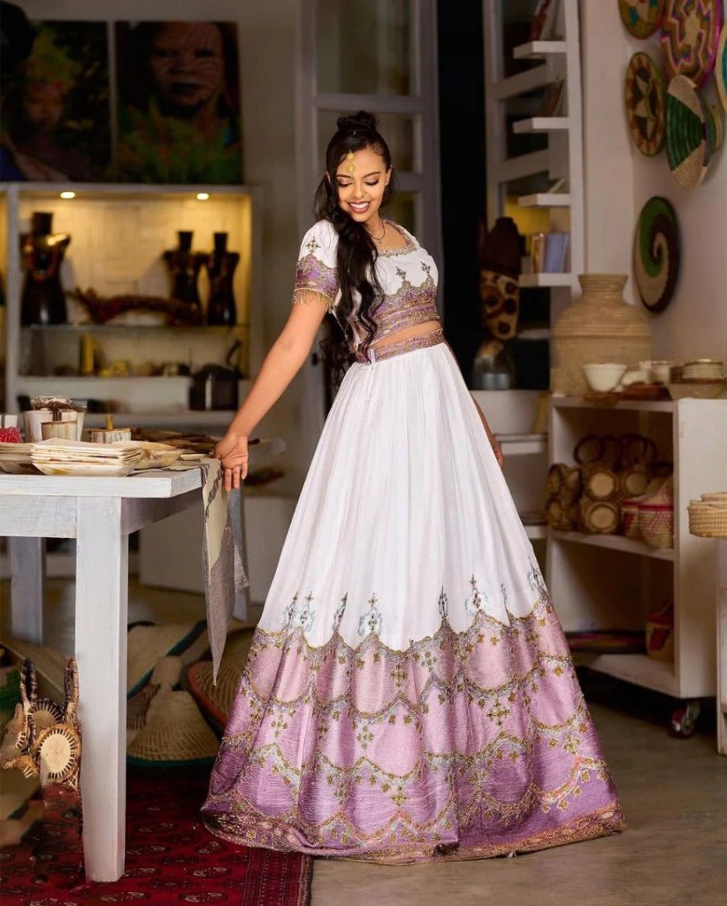 Stunning Ethiopian Traditional Wedding Dress in Lavender with Intricate Gold Detailing
