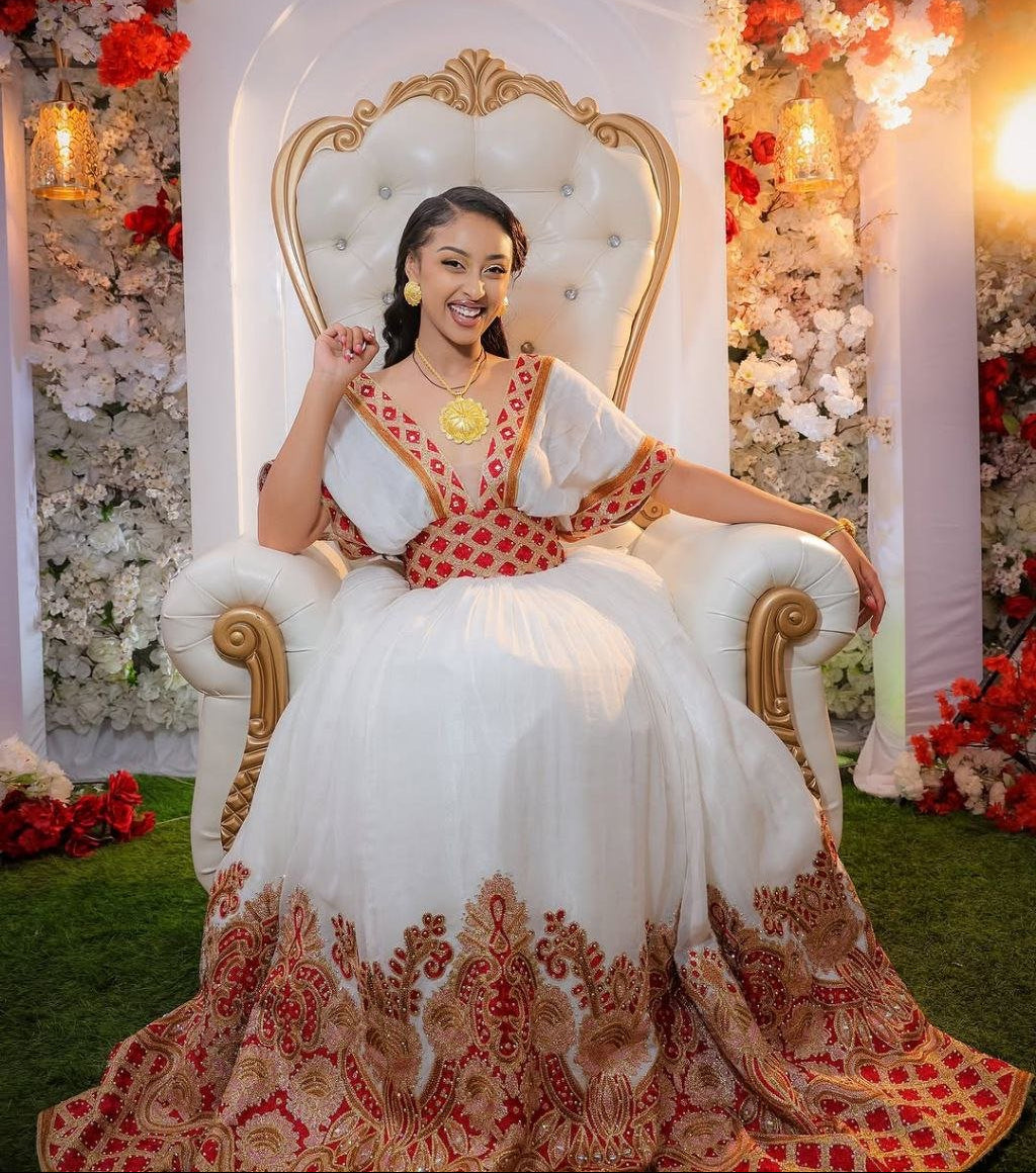  A Bride’s Bold Elegance: Radiant Red Habesha Dress with Golden Embroidery Glow
