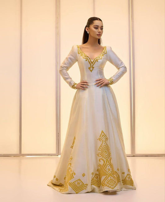 Elegant Ivory Habesha Wedding Dress with Intricate Gold Embroidery For A Wedding