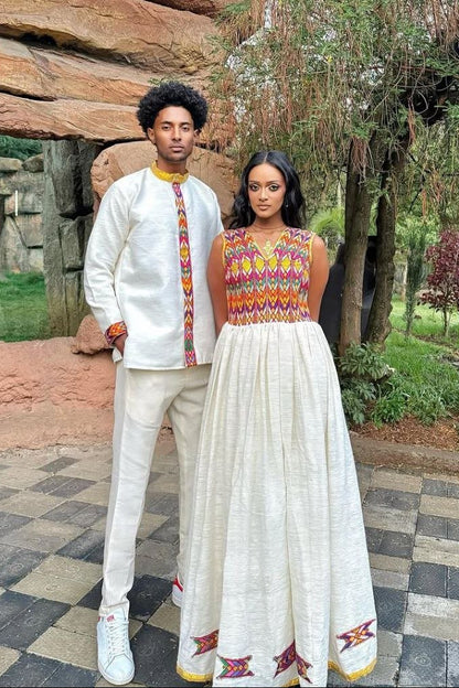 Stylish Traditional Ethiopian Couple's Attire with Vibrant Red, Yellow, and Green Embroidery for Celebrations
