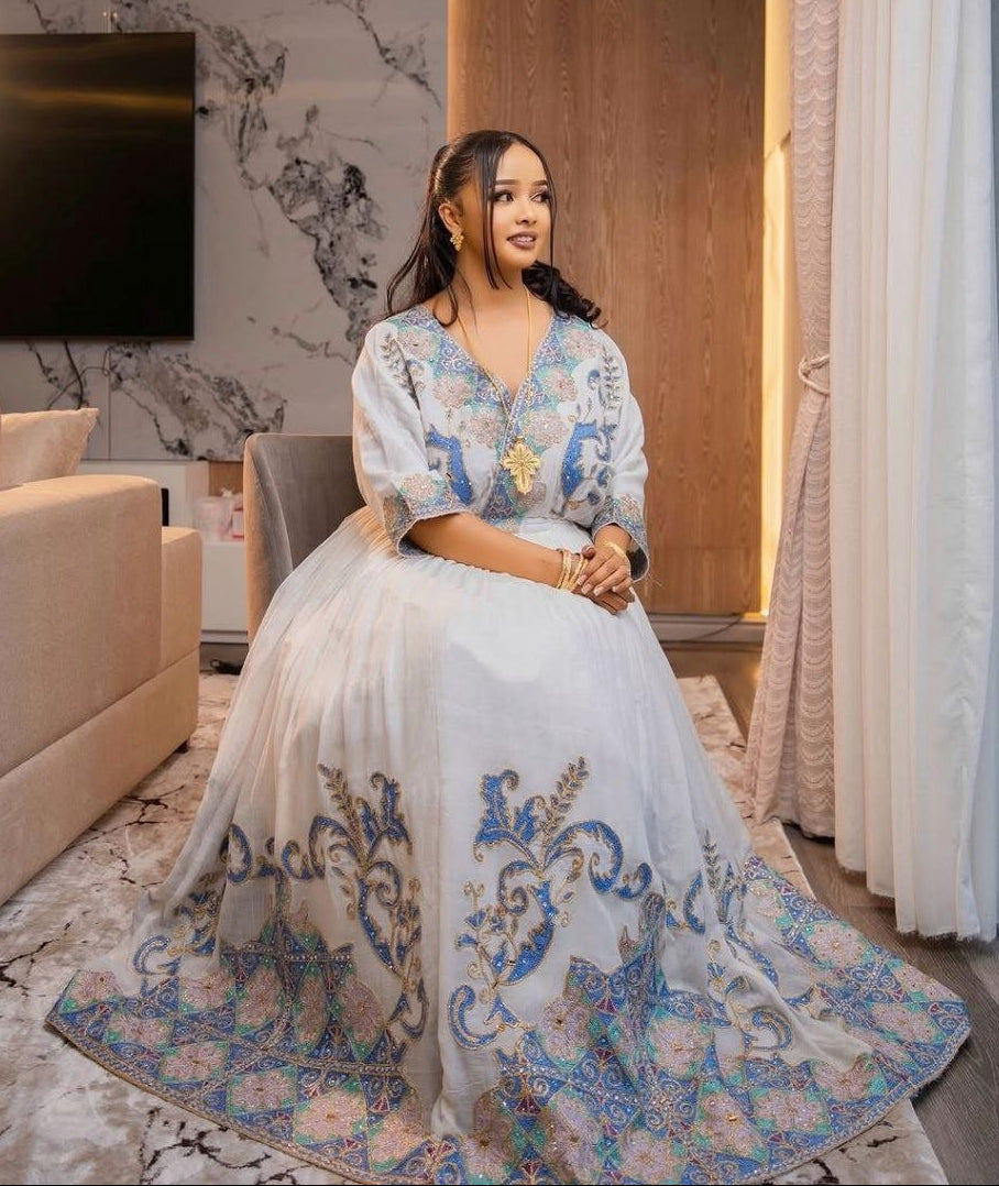 Graceful Habesha Kemis with Pastel Blue and Gold Embroidery for Engagements and Celebrations

