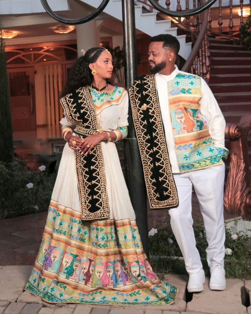 Chic Habesha Couple's Attire with Colorful Embroidery for Celebrations
