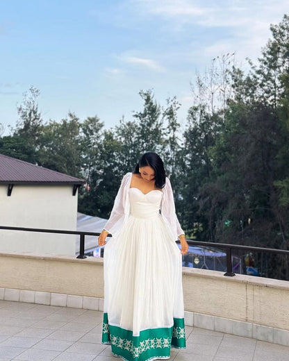 Radiant Habesha Dress with Elegant Green Embroidery a Beautiful Choice for an event