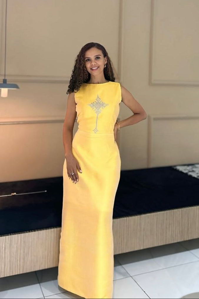 Elegant Yellow Simple Habesha Dress with Subtle Traditional Cross Design For an Event
