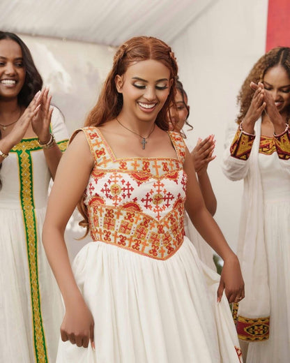 Elegant Habesha Kemis with Vibrant Red and Gold Embroidery for Your Wedding