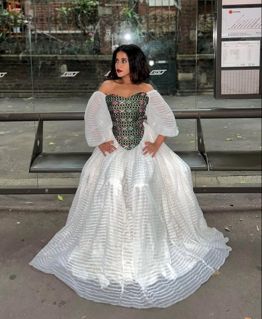 Vibrant Off-Shoulder Habesha Kemis Elegant Ethiopian Dress with Multi-Color Embroidered Bodice
