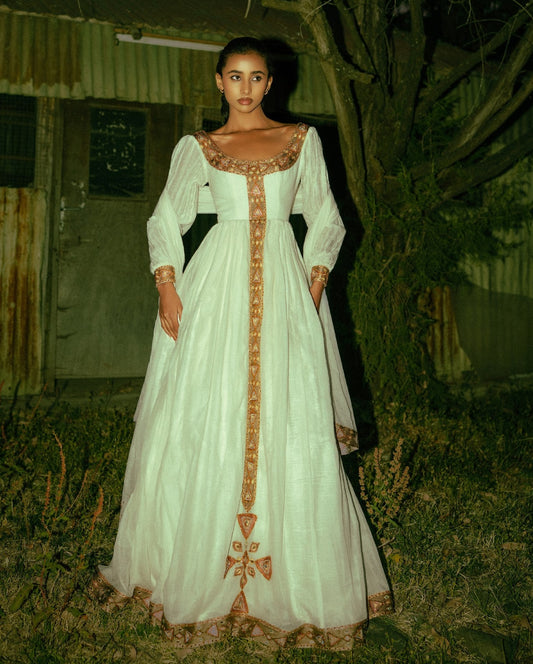Timeless White Ethiopian Cultural Gown with Ornate Gold Handwoven Details 