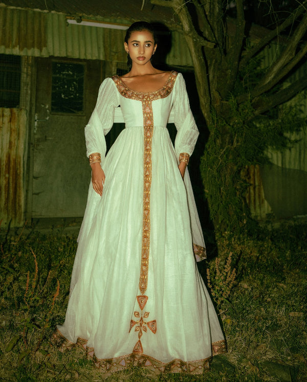 Timeless White Ethiopian Cultural Gown with Ornate Gold Handwoven Details 