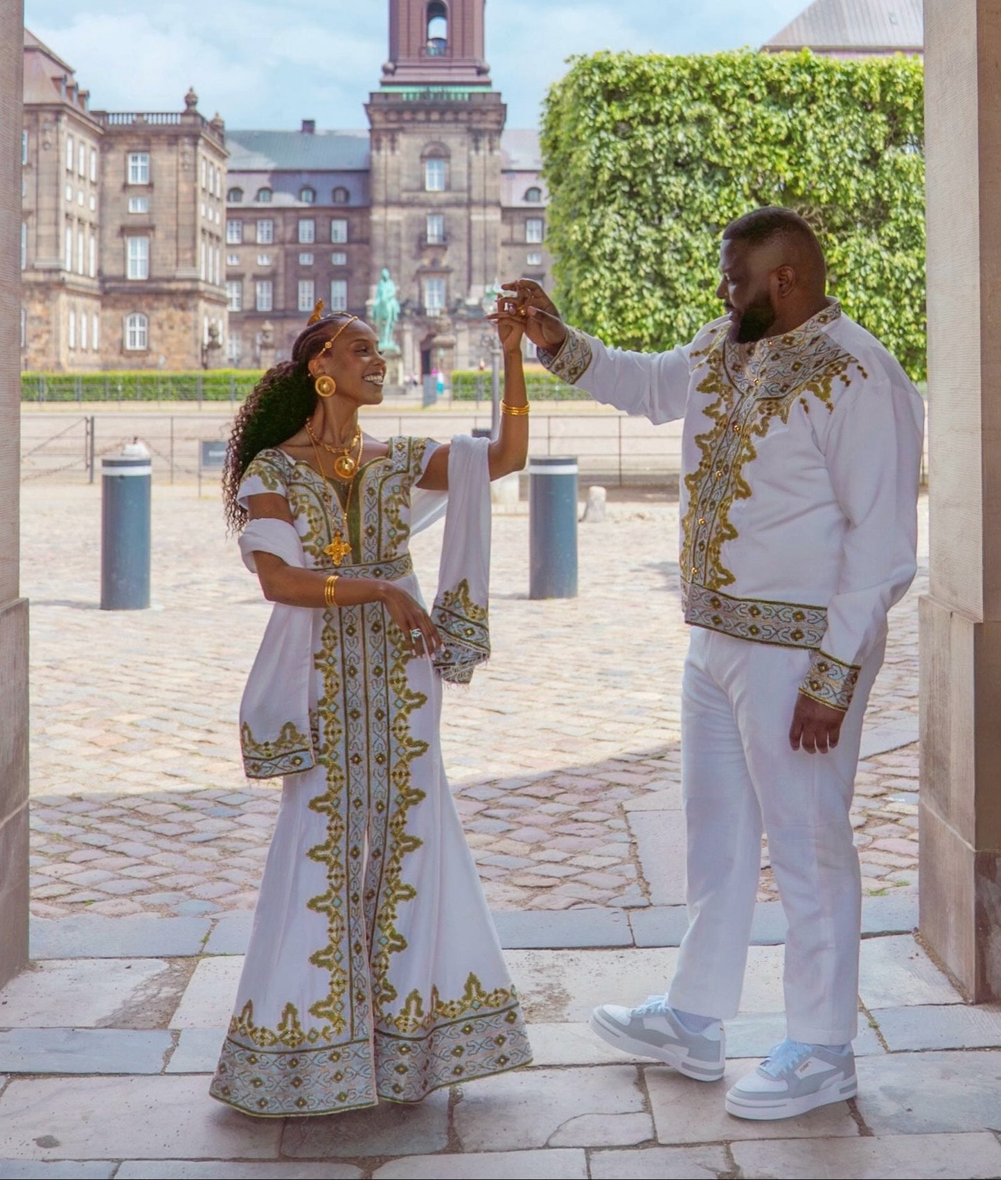 matching ethiopian couple outfit in crisp white with royal gold and sage green habesha matching embroidery
