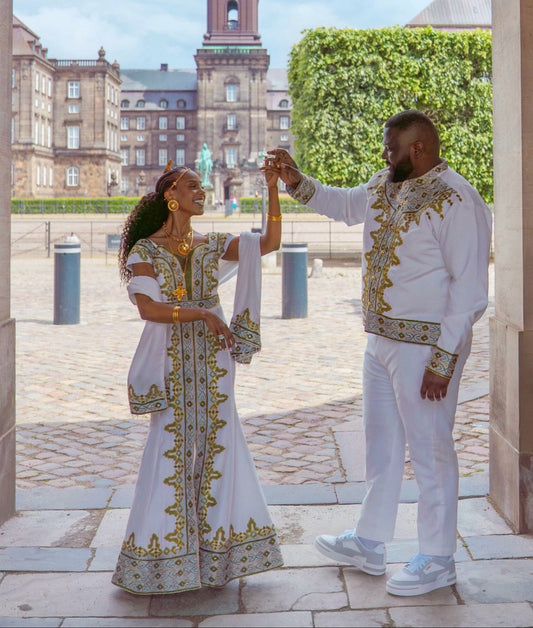 matching ethiopian couple outfit in crisp white with royal gold and sage green habesha matching embroidery